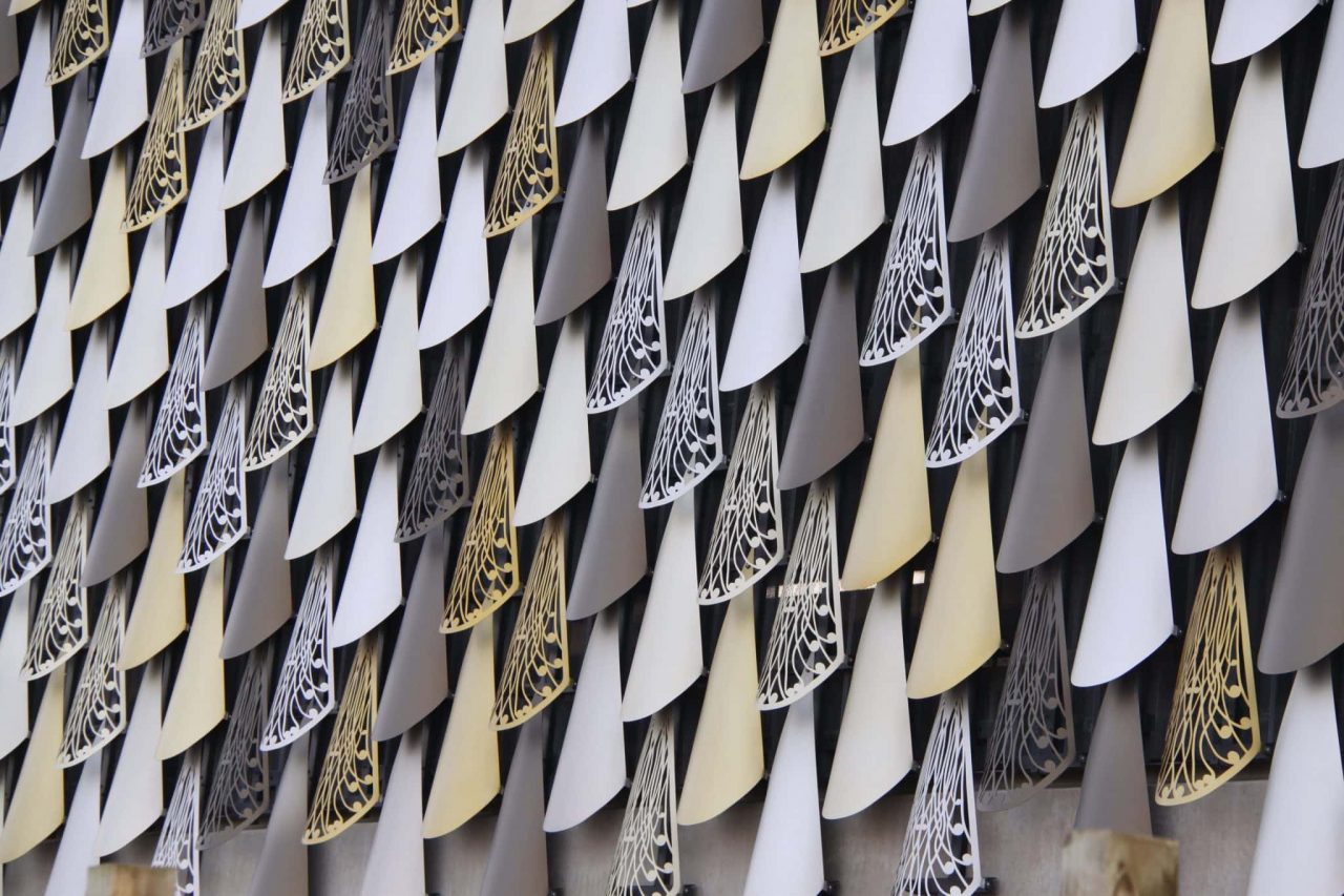 Sculpted precast public facade in daylight with deep textured relief